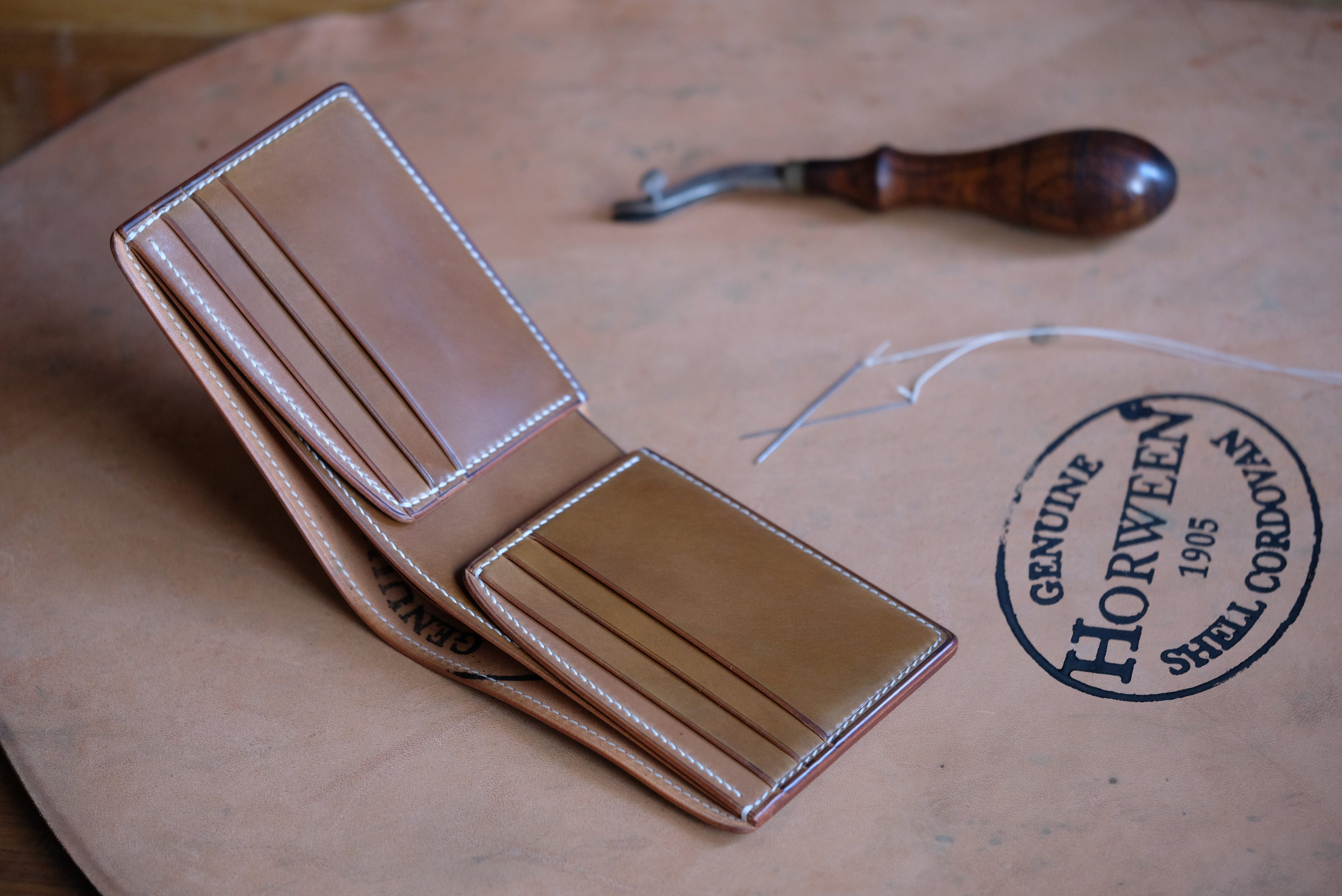 Horween shell cordovan bifold wallet on Horween leather stamp